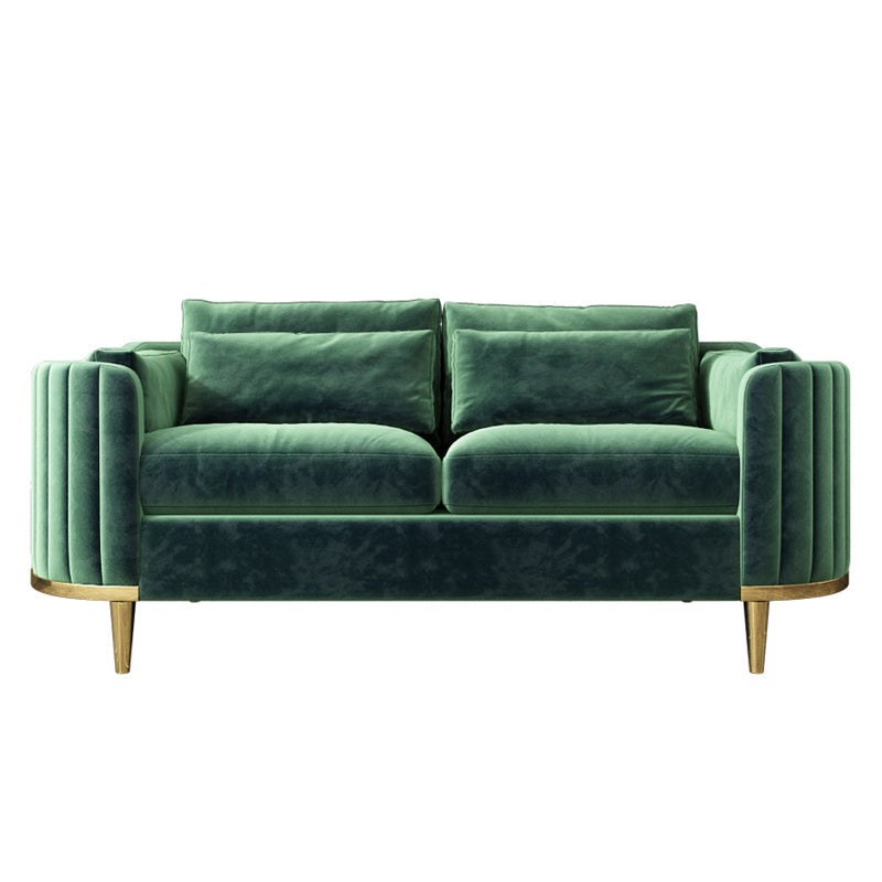 Green velvet sofa with gold legs on a white background