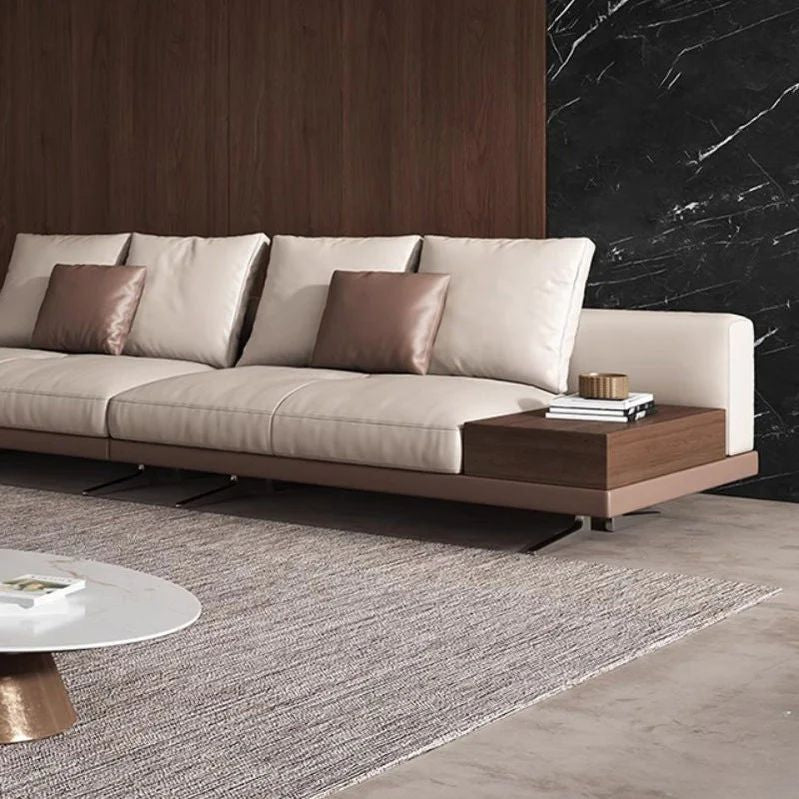 "Modern beige sofa with wooden coffee table in a living room setting"