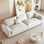 White sofa in a living room with a small table and decorative items. Nordic style sofa, minimalist sofa design, aesthetic modern sofa design, living room furniture. 