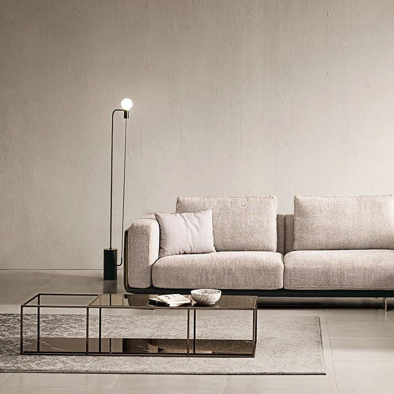 "Philips_Modern_Vanessa_Luxury_Sofa_Style-  Modern living room with a gray sofa, coffee table, and floor lamp."