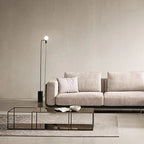 "Philips_Modern_Vanessa_Luxury_Sofa_Style-  Modern living room with a gray sofa, coffee table, and floor lamp."
