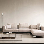 "Philips Modern Vanessa Luxury Sofa Style -Gray sectional sofa in a minimalistic living room with a lamp and coffee table."
