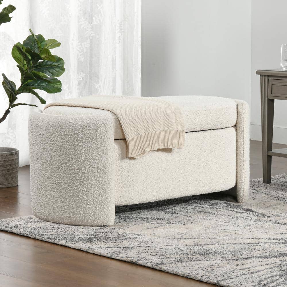 "White textured sofa with a beige blanket in a living room setting."