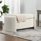 "White textured sofa with a beige blanket in a living room setting."