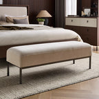 Beige upholstered bench in front of a bed in a bedroom setting. Bedroom accessories, Minimalist bench chair. 