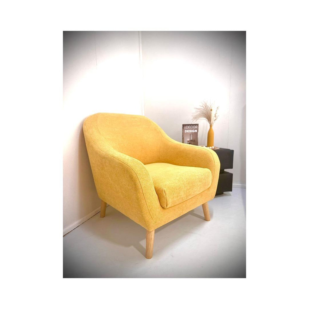 Yellow armchair in a minimalistic room with white walls and a light gray floor. Comfortable chair.