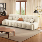 White sofa in a living room with a wooden coffee table and decorative items. Sectional sofa, Armless sofa, Sleeper sofa. 