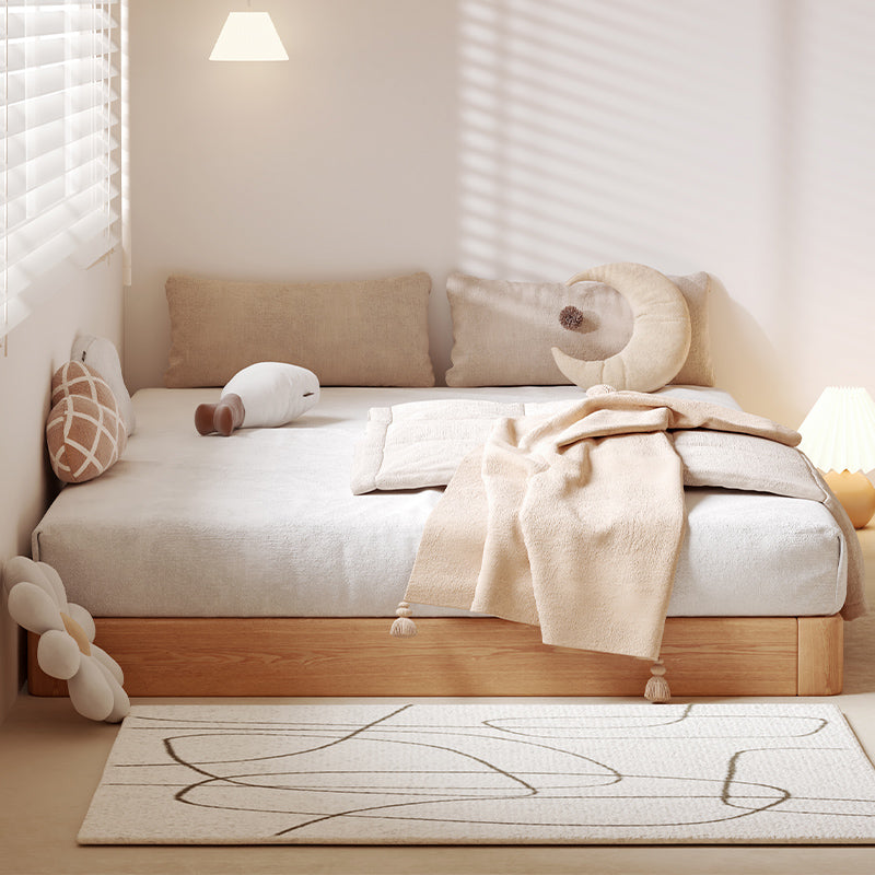 Nursery room with a wooden crib, beige bedding, and decorative pillows. Wooden bedframe, Scandinavian bedframe design, neutral bedframe color, aesthetic bed design, modern bedframe design. 