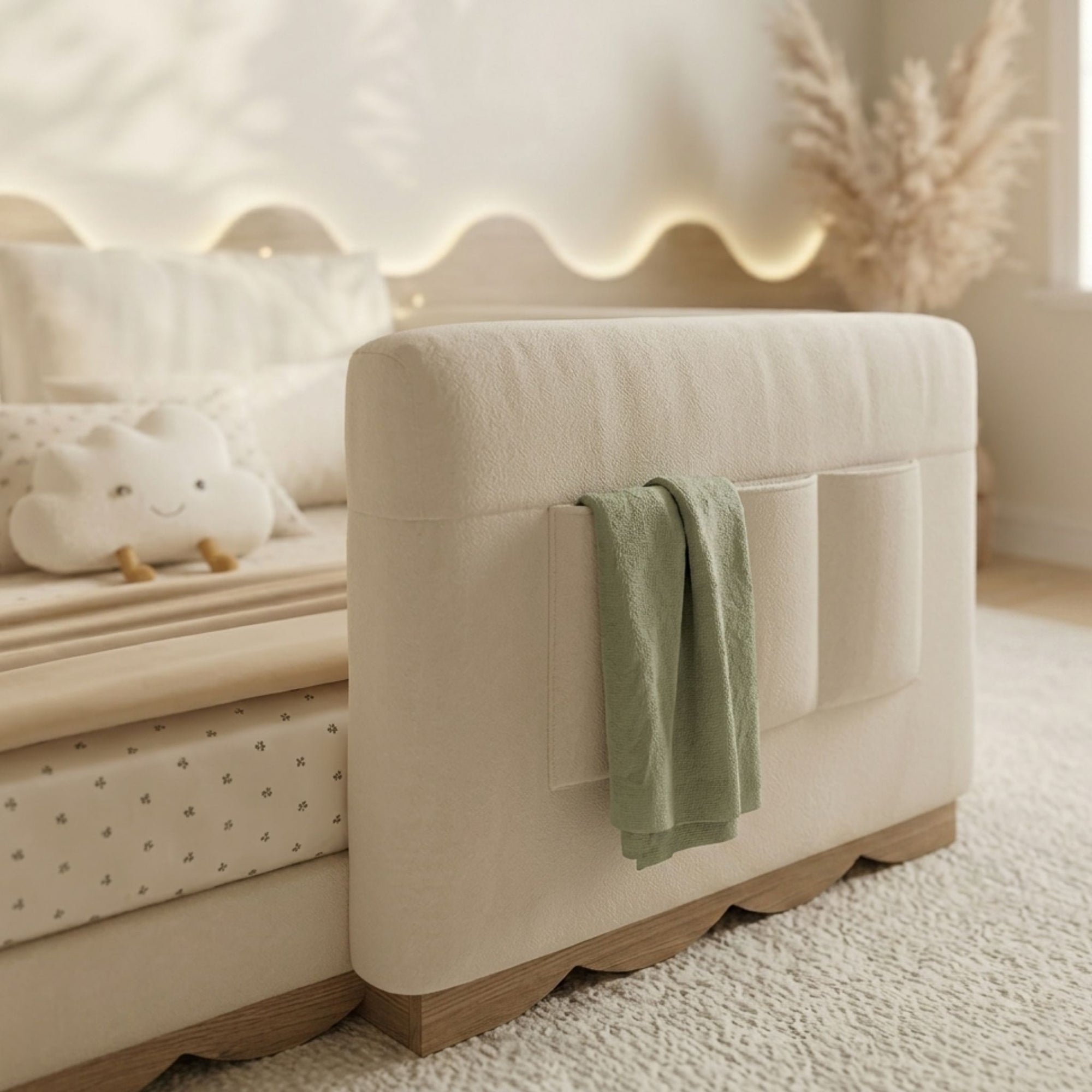 Detail view of the Anaya floor bed’s upholstered side rail featuring integrated storage pockets and scalloped wood trim