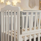 Close-up of the smooth rounded spindles and non-toxic finish on the Celestia 90x140cm nursery crib