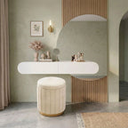 A wide-angle lifestyle shot showing the floating dressing station paired with a coordinating pleated velvet ottoman in a modern interior