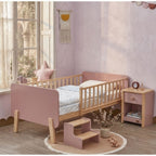 A minimalist UAE children's bedroom featuring the 120x200cm Tuck-Me-In Transition Sleeper as a secure and stylish focal point
