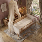 Detailed view from above of the Norse Scandi Toddler Bedframe, showing the natural wood spindle side rails, white end panels, and standard toddler mattress, handcrafted by Philips Modern Homes