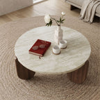A close-up perspective of the Terra Marble Occasional Coffee Table highlighting the organic texture of the travertine stone top and the curved sculptural wood supports