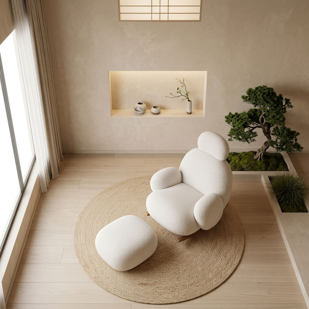 A full-scene view of the Velia white boucle rocking chair and ottoman in a serene, nature-inspired Japandi bedroom beside a large window, featuring natural materials, a bonsai tree, and a cast-iron tea set on a jute rug